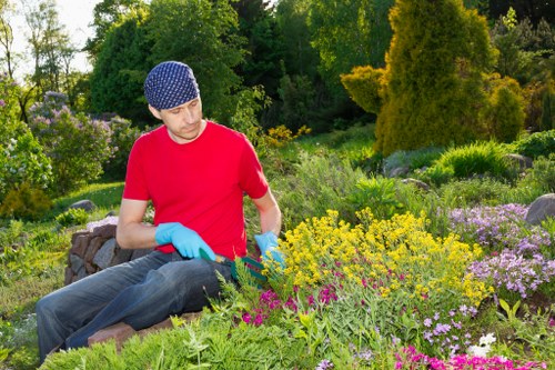 Trained gardeners using safe working practices outdoors